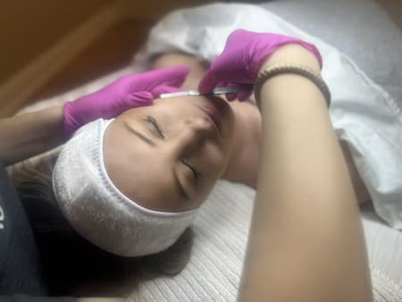 The doctor cosmetologist making mesotherapy injections in woman's head for stronger and healthier hair