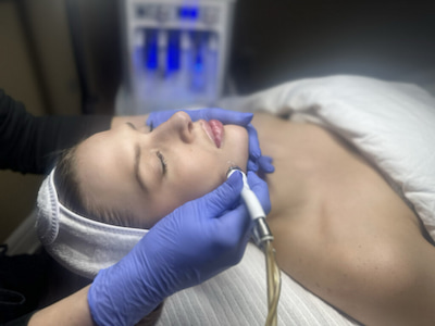 Cosmetology Spa woman doing procedures on the face of the medical equipment