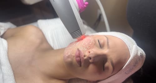 Beautician Using Laser Therapy For Facial Skin Rejuvenation for Body Treatment of Healthy Woman Face Getting Skin Resurfacing In Spa Salon. Horizontal image Composition