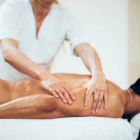 Sports massage - Arm massage - Physical therapist doing massage of arms. Toned image, selective focus set on hands.
